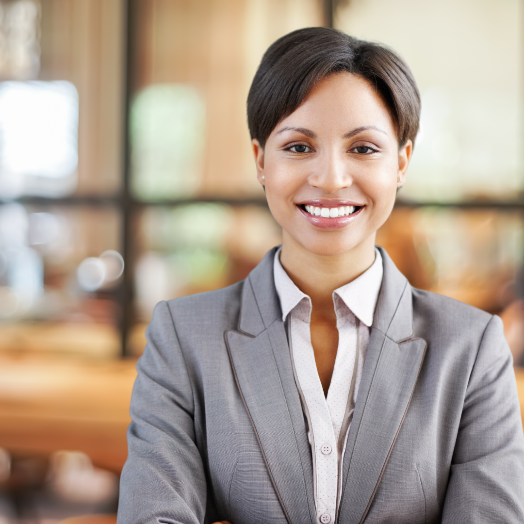 Confident African American female leader standing in office