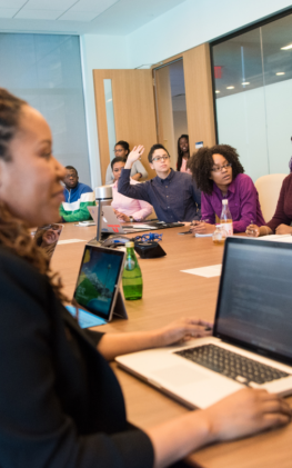 Large Team Learning Around a Wooden Conference Room Table